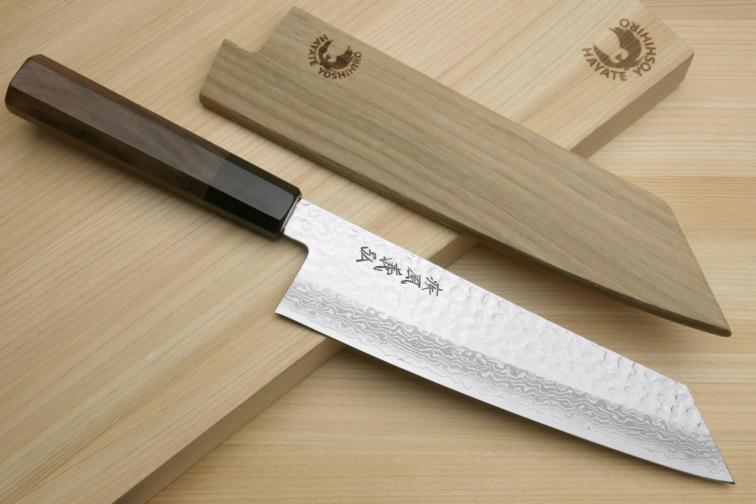 Kiritsuke Japanese chef knife with hammered Damascus blade and dark octagonal handle