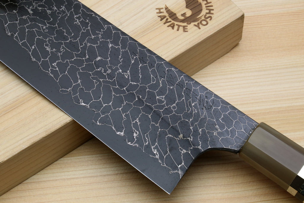 Nakiri vegetable knife with dark Damascus pattern near rounded heel