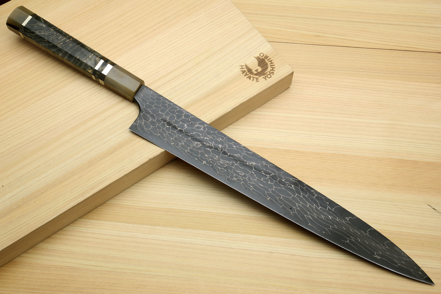 Sujihiki slicer knife with black Damascus snake-skin pattern blade and dark handle