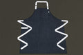 Dark denim kitchen apron with white trim, chest pocket, and deep side pockets