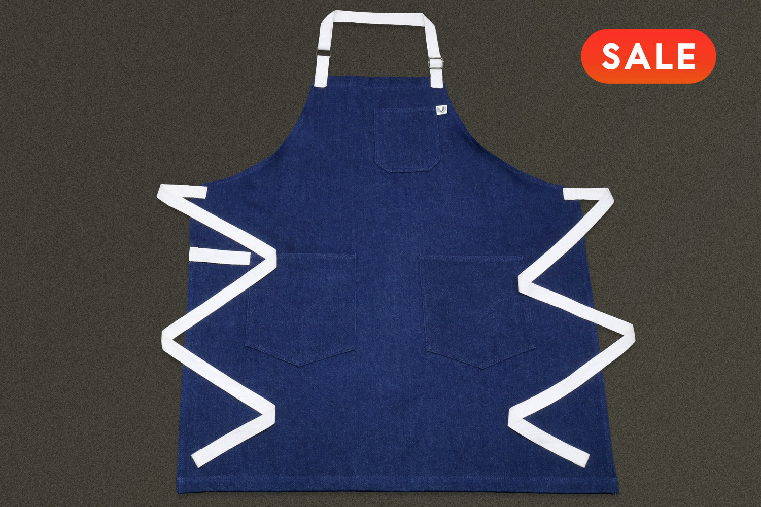 Dark denim kitchen apron front view with adjustable neck strap and waist tie