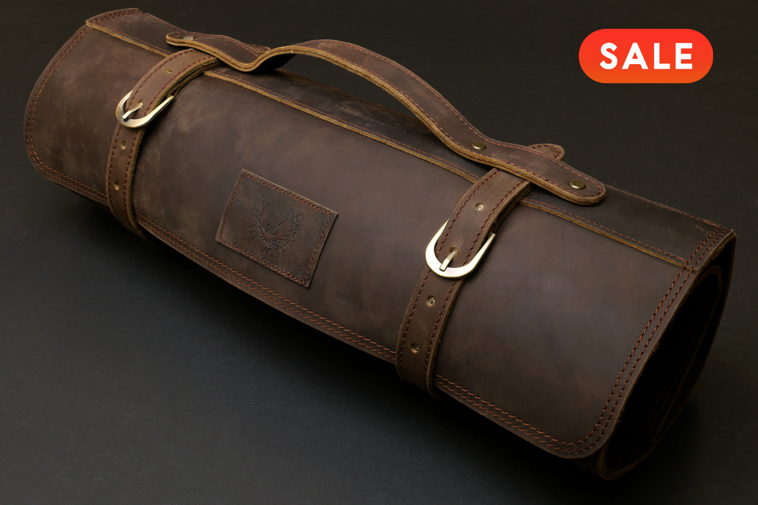 Brown leather knife roll storage case with carry handle and metal ring closures, SALE badge.
