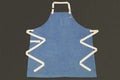 Light blue denim kitchen apron with square chest pocket and cream straps
