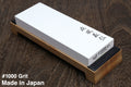 Yoshihiro Toishi 1000 grit sharpening whetstone on wooden base, white stone with label