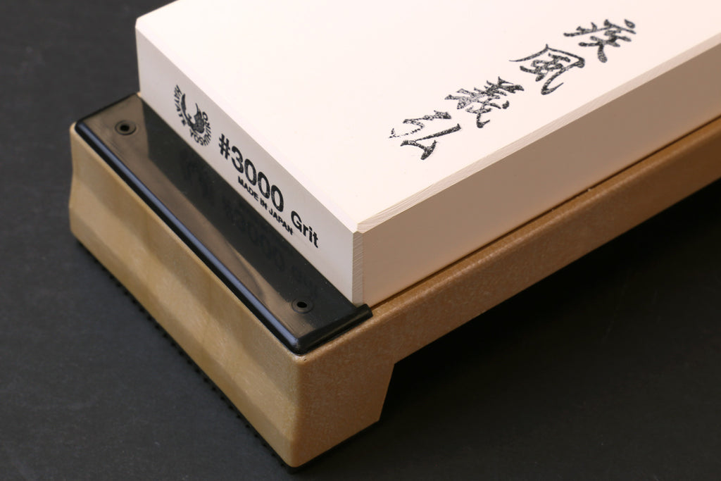 Sharpening whetstone 3000 grit white block on dark base with black side supports