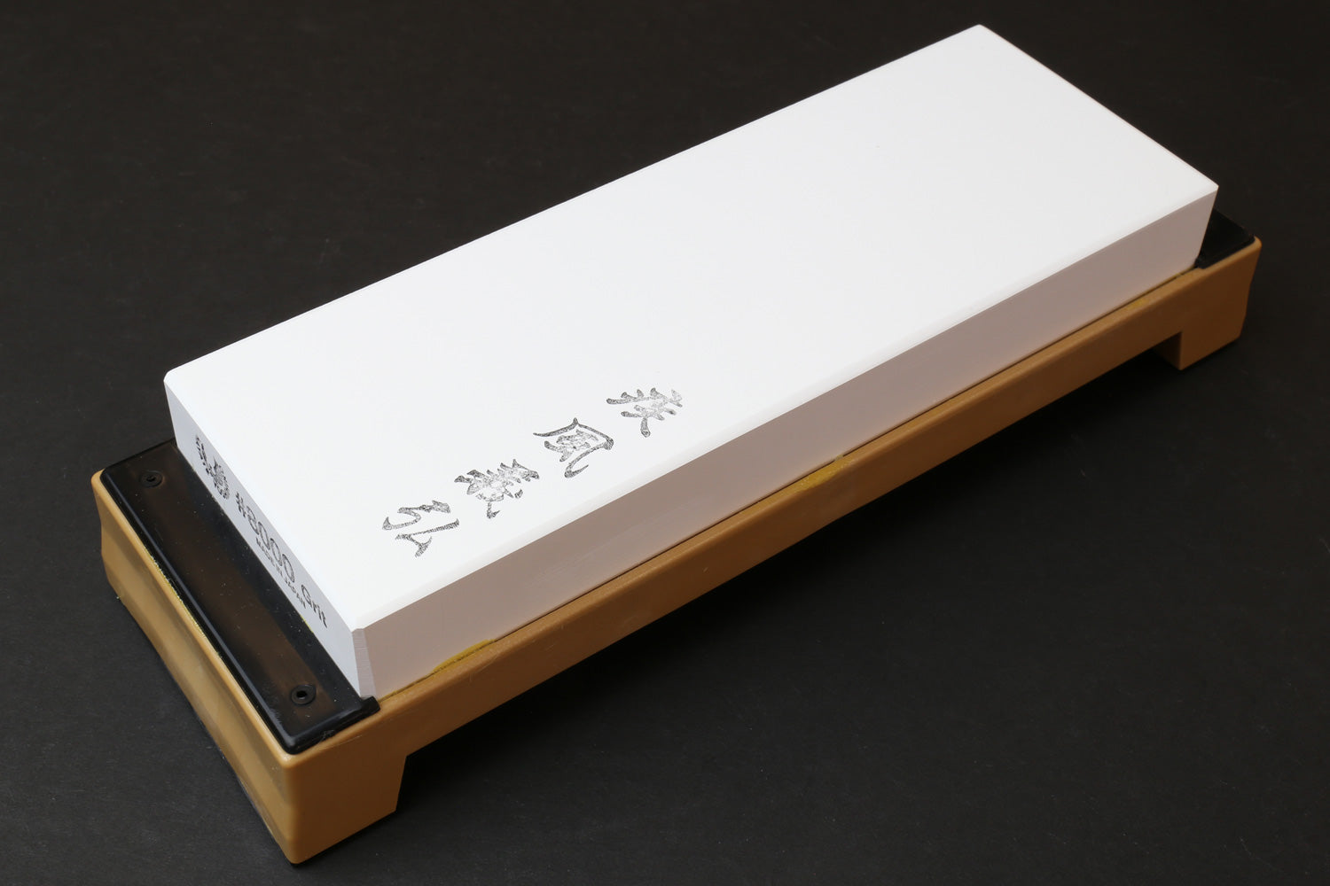 8000-grit sharpening whetstone, white rectangular stone on tan base with black insert
