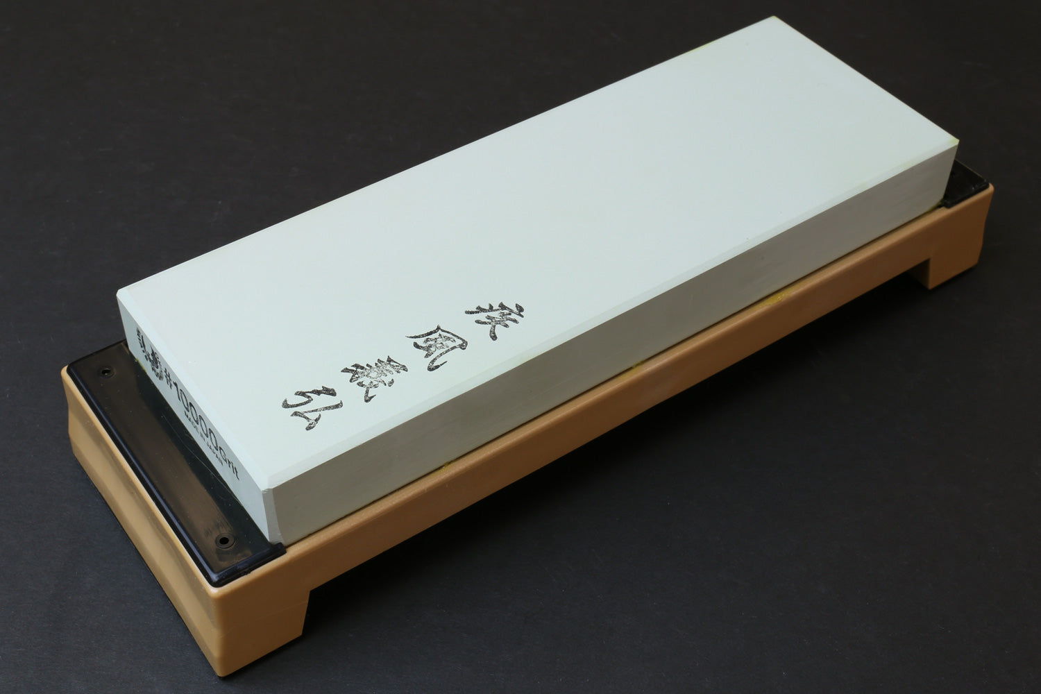 10,000-grit sharpening whetstone on base, pale green rectangular stone