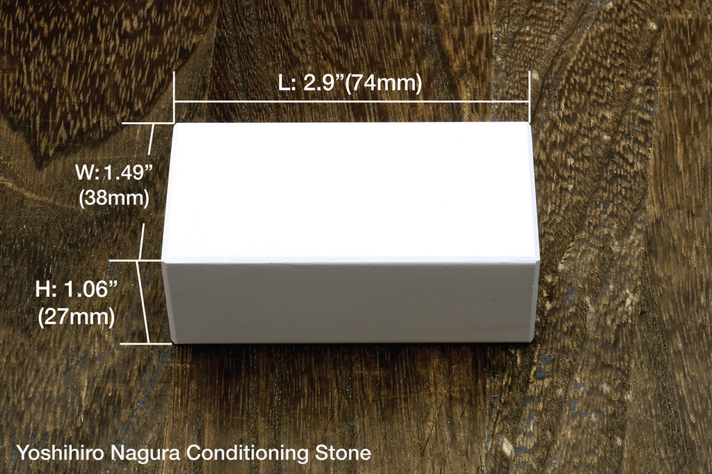 Rectangular black sharpening stone with smooth face and visible size markers