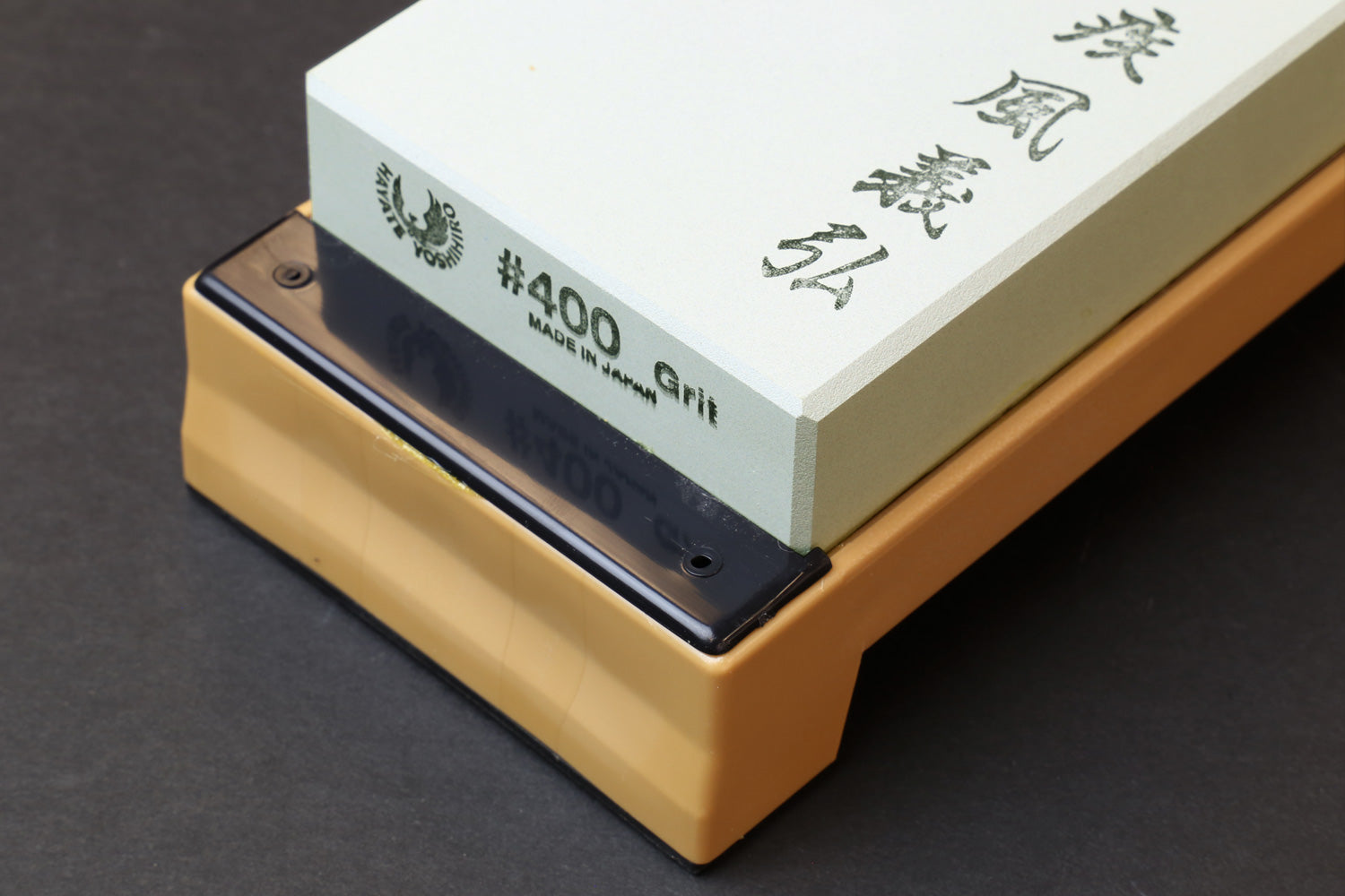 400 grit whetstone block on beige base, white stone with engraved branding