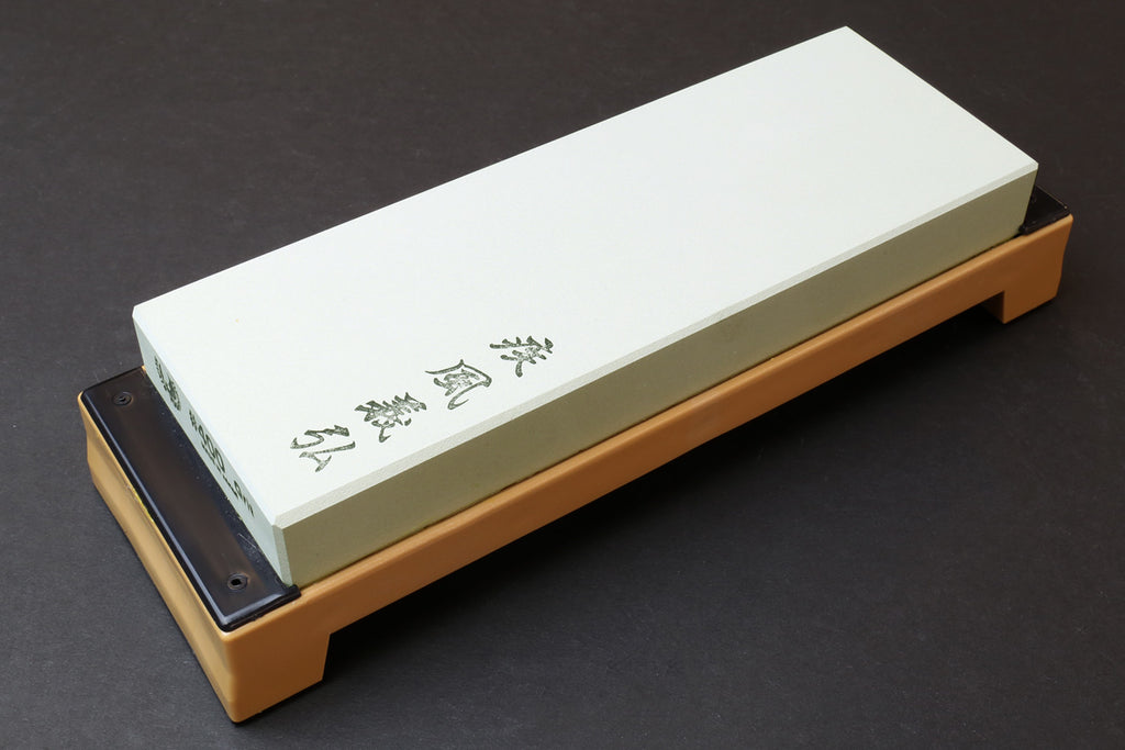 400-grit sharpening whetstone with white stone on beige base, metal-side holes