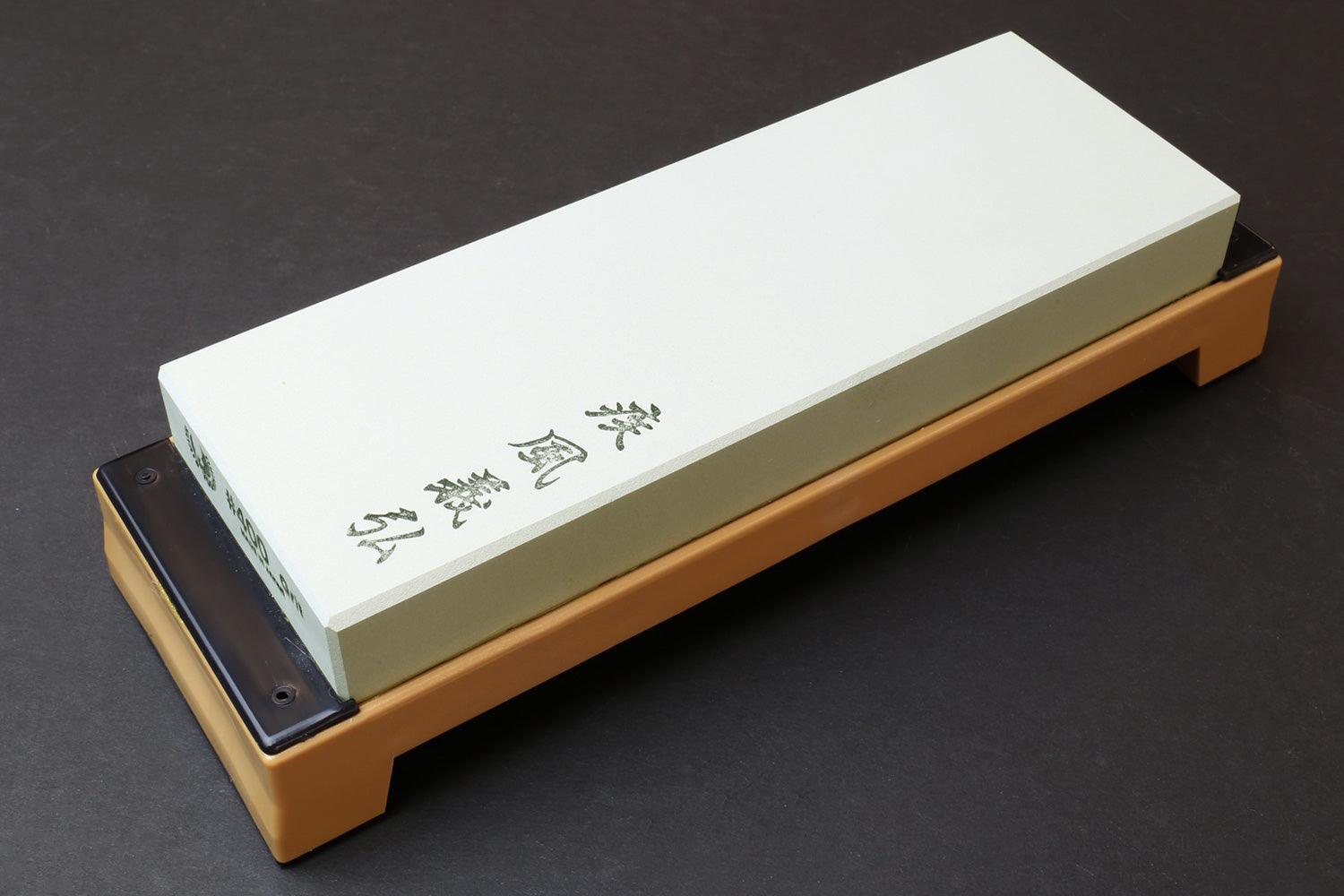400-grit sharpening whetstone with white stone on beige base, metal-side holes
