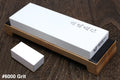 6000 grit sharpening whetstone with white stone on tan base, rectangular black label