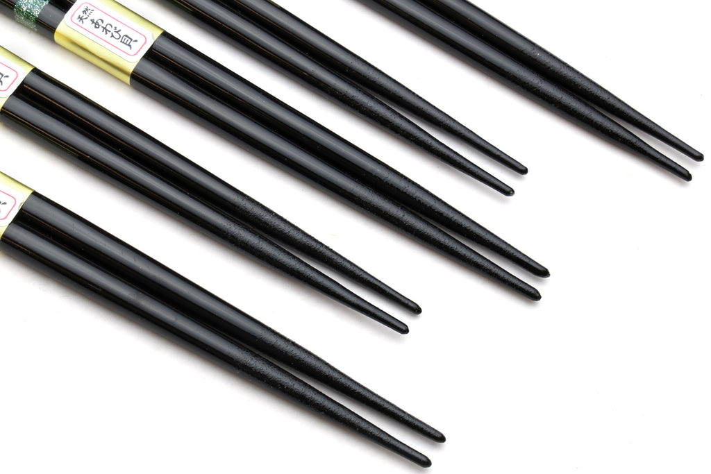 Black chopstick tips with patterned grip sections in view