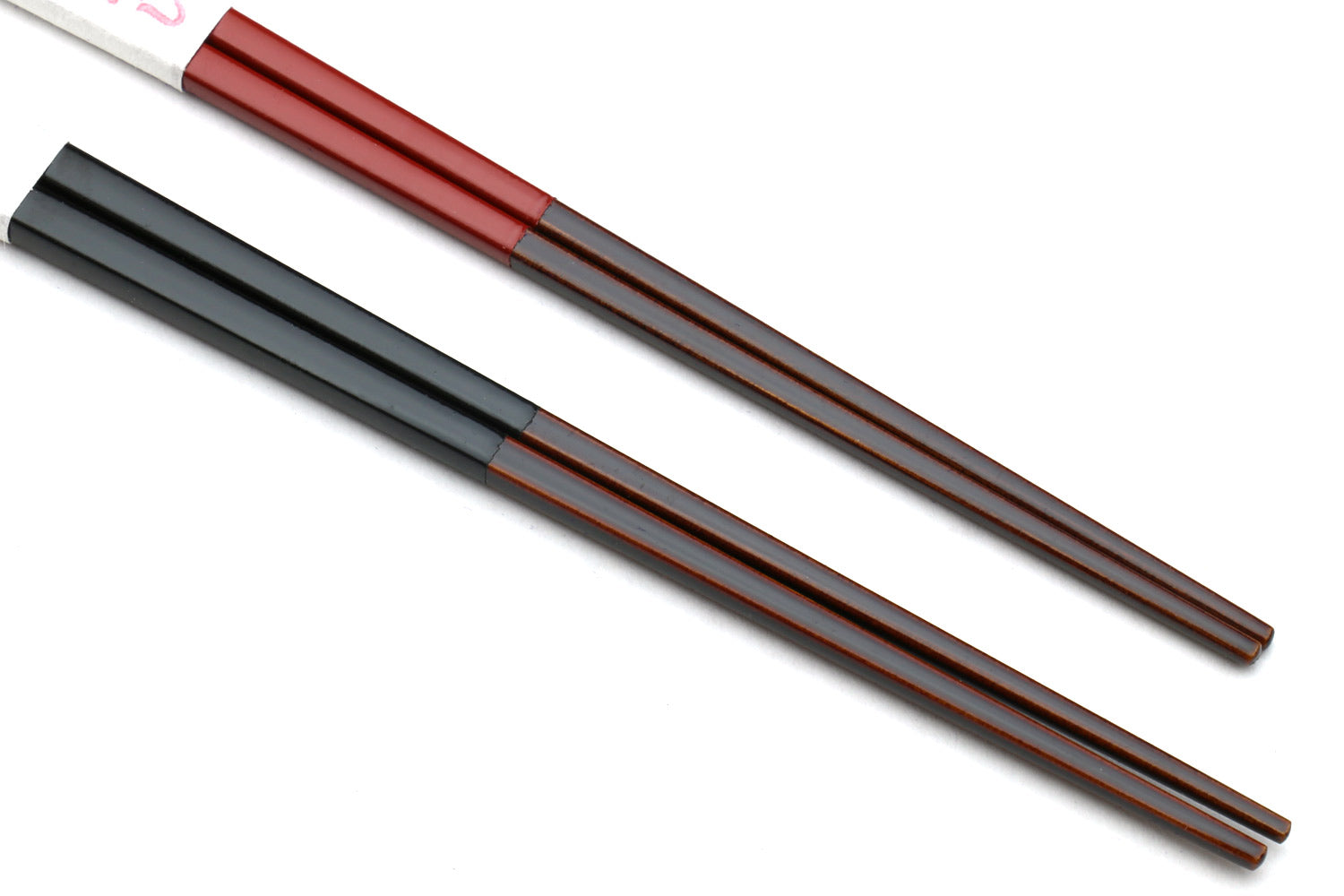 Red and black chopsticks with patterned grip and tapered ends