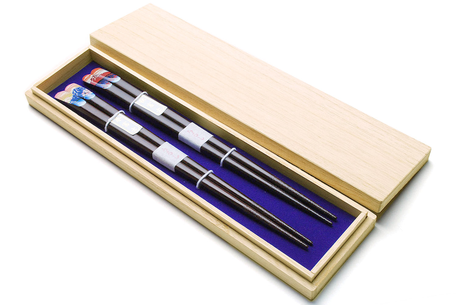Lacquered chopsticks set in pale wood storage box, black shafts with blue and red accents