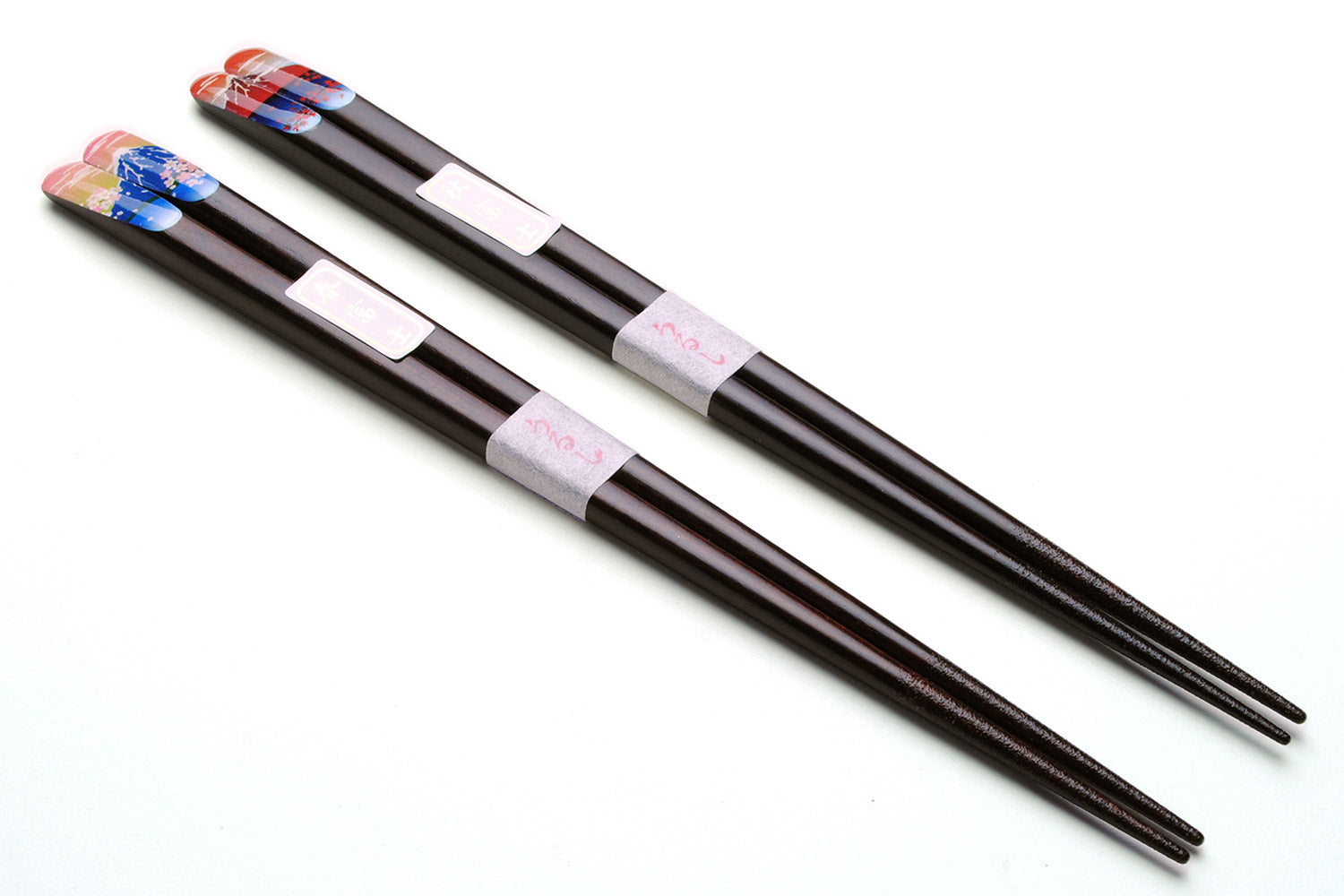 Pair of lacquered chopsticks with black finish, white grips and blue red decorative ends