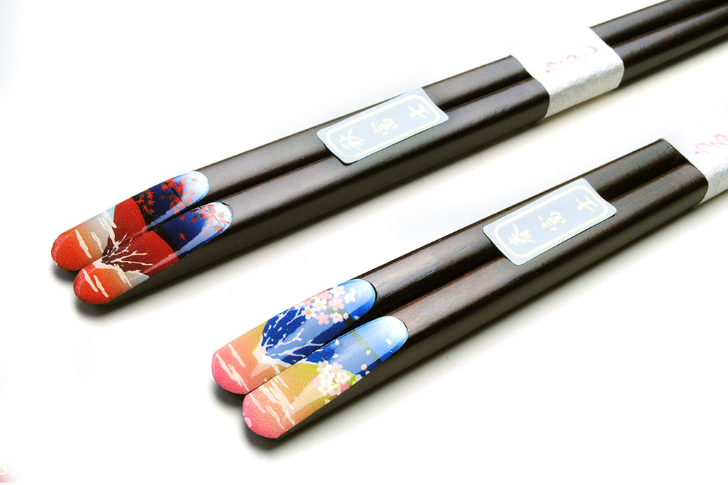 Decorated lacquered chopstick pair with black shafts and colorful scenic end caps