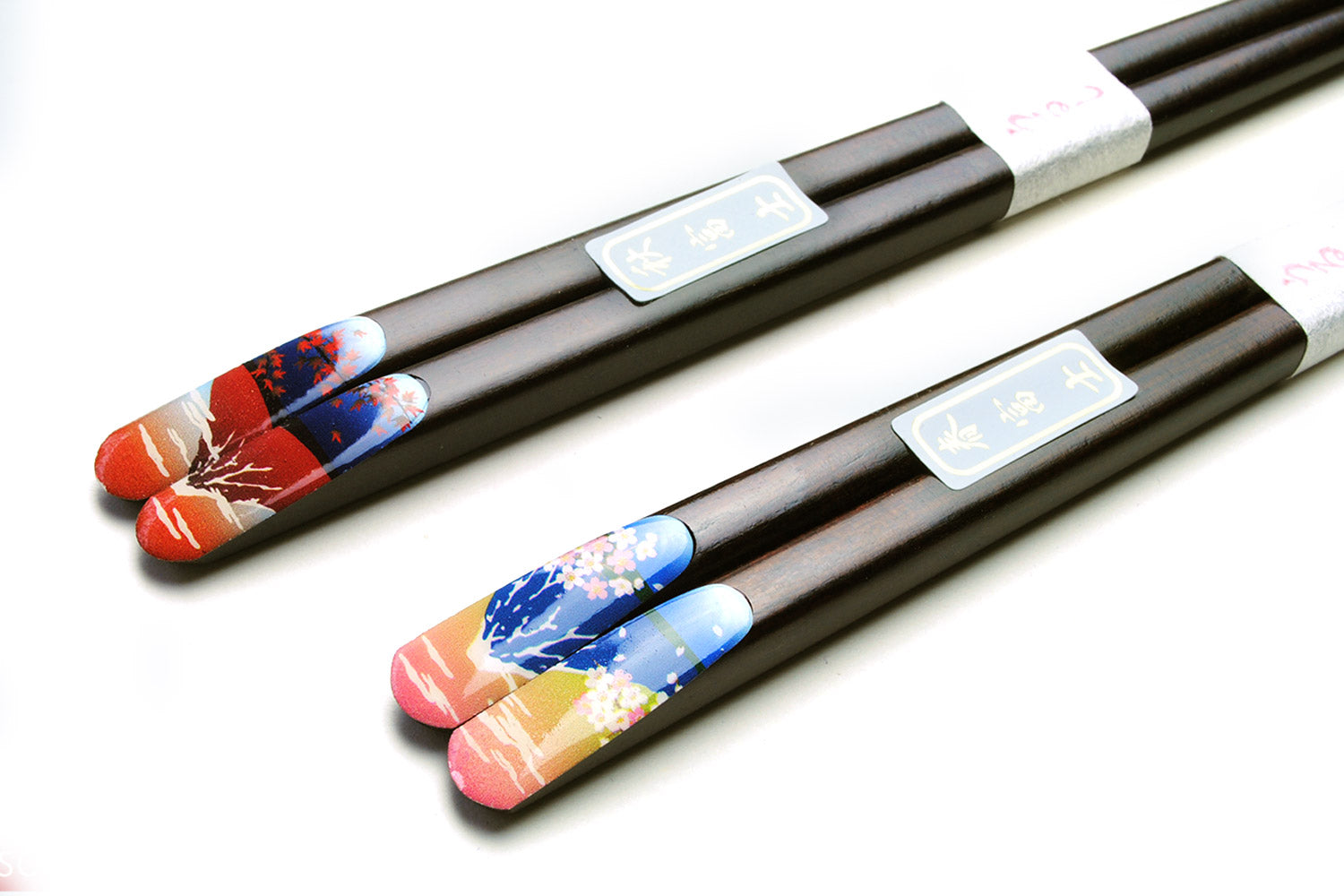 Decorated lacquered chopstick pair with black shafts and colorful scenic end caps