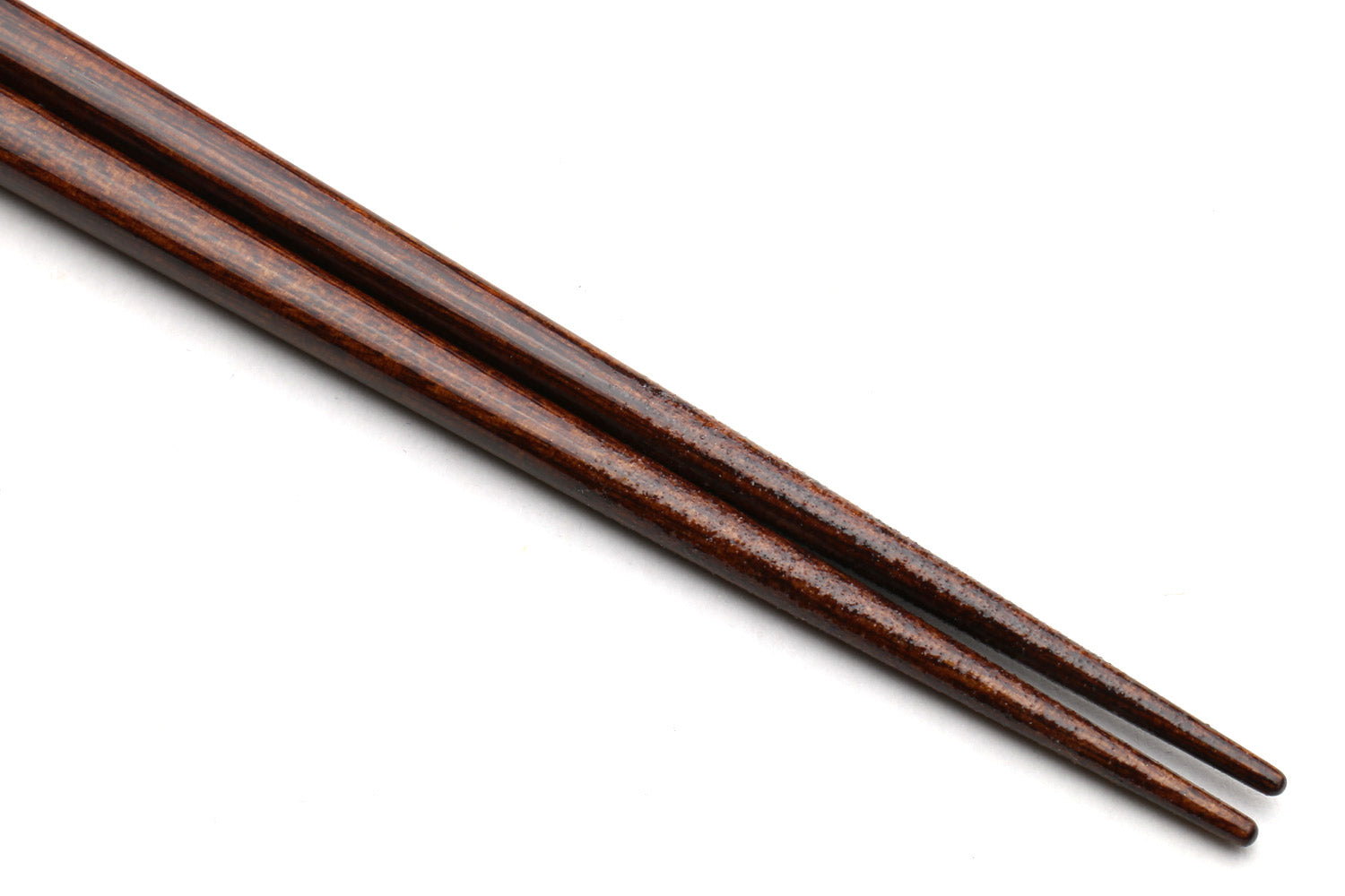 Pair of dark brown lacquered chopsticks with tapered ends