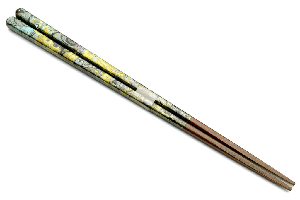 Pair of lacquered wooden chopsticks with green, black, and yellow marble finish