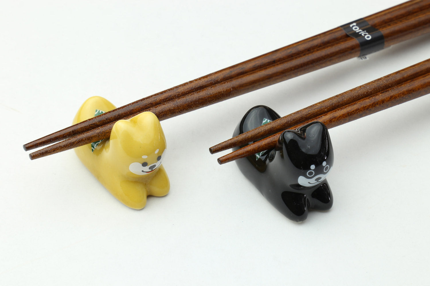 Twin pair chopsticks with shiba inu tip holders on brown lacquer shafts