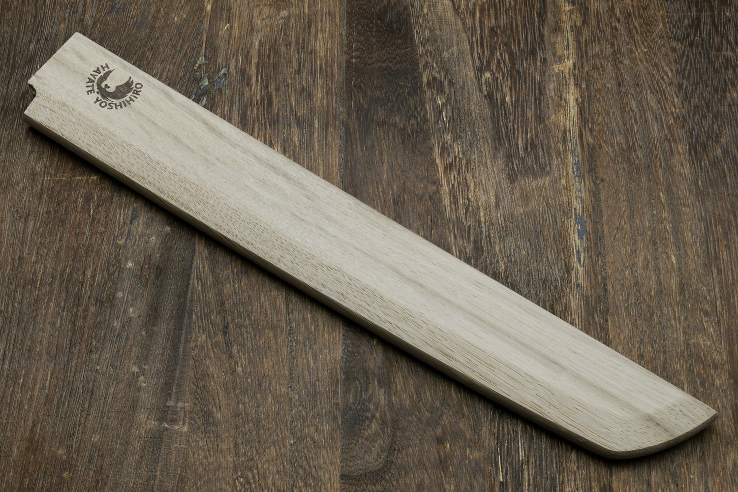 Light oak wooden saya cover with carved logo and tapered end