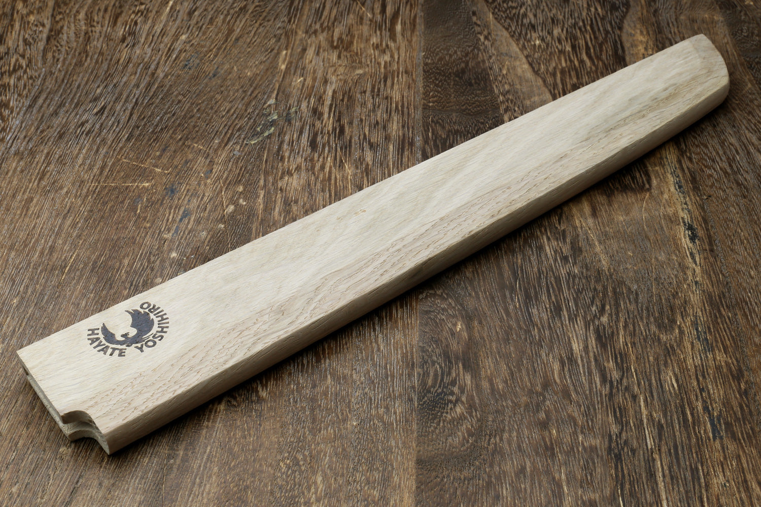 Light oak wooden saya cover with carved logo and rounded throat