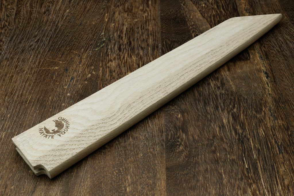 Light oak wooden saya cover with pointed tip and brand logo, side view