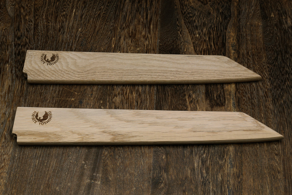 Pair of light oak wooden saya covers with brand emblems, side by side