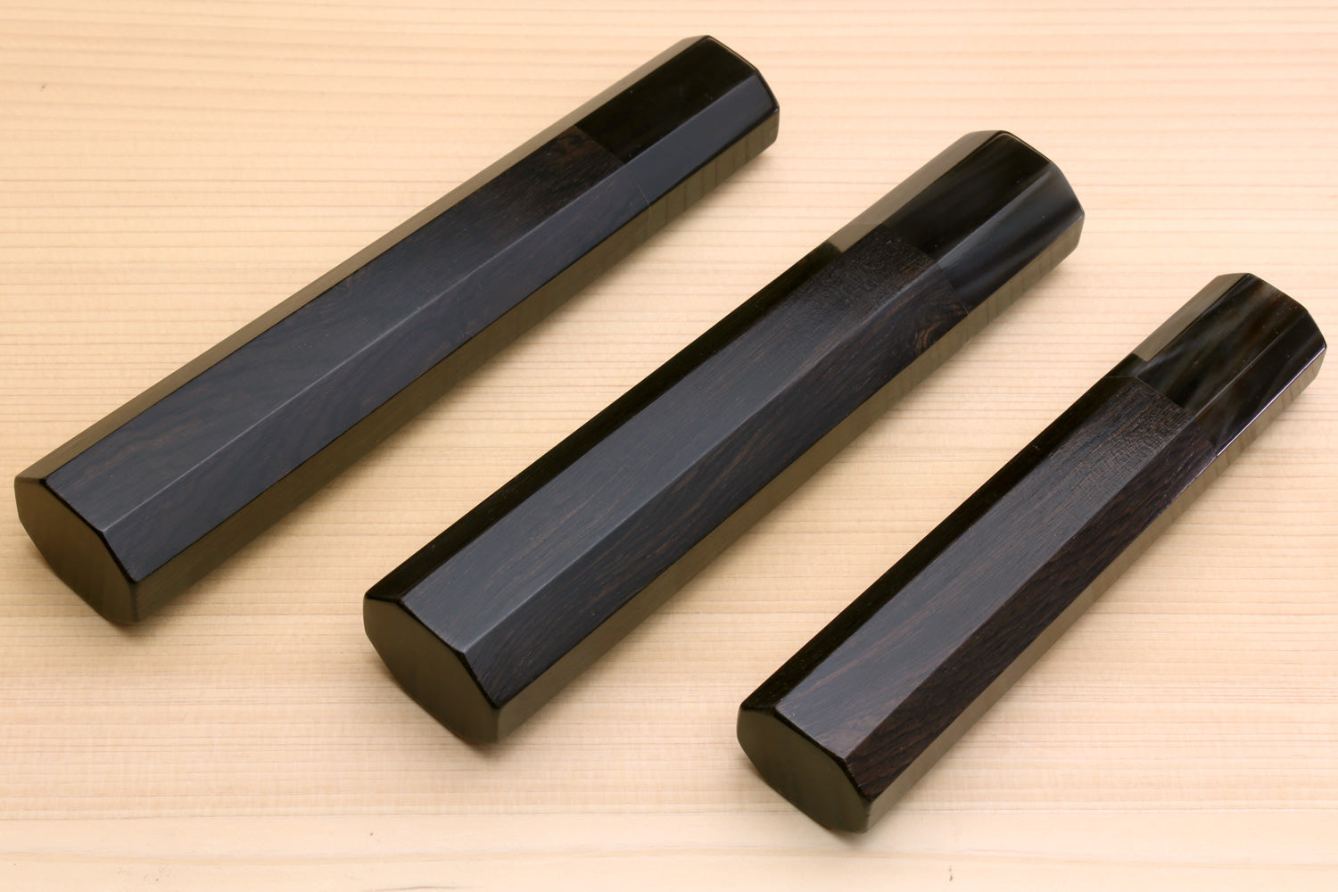 Set of ebony knife handle blanks with horn bolsters, three angled views