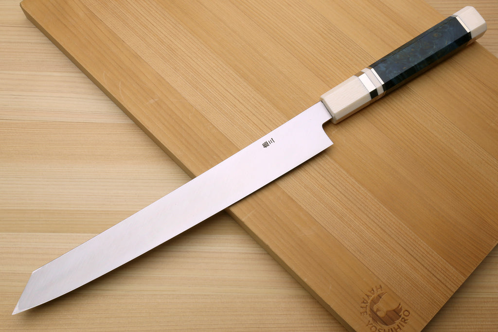 Japanese sushi knife with polished blade and dark handle paired with ivory bolster