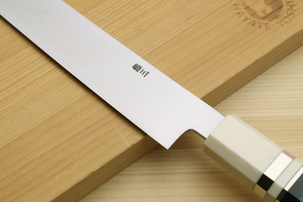 Sashimi yanagi knife blade and ivory handle with engraved logo on the blade