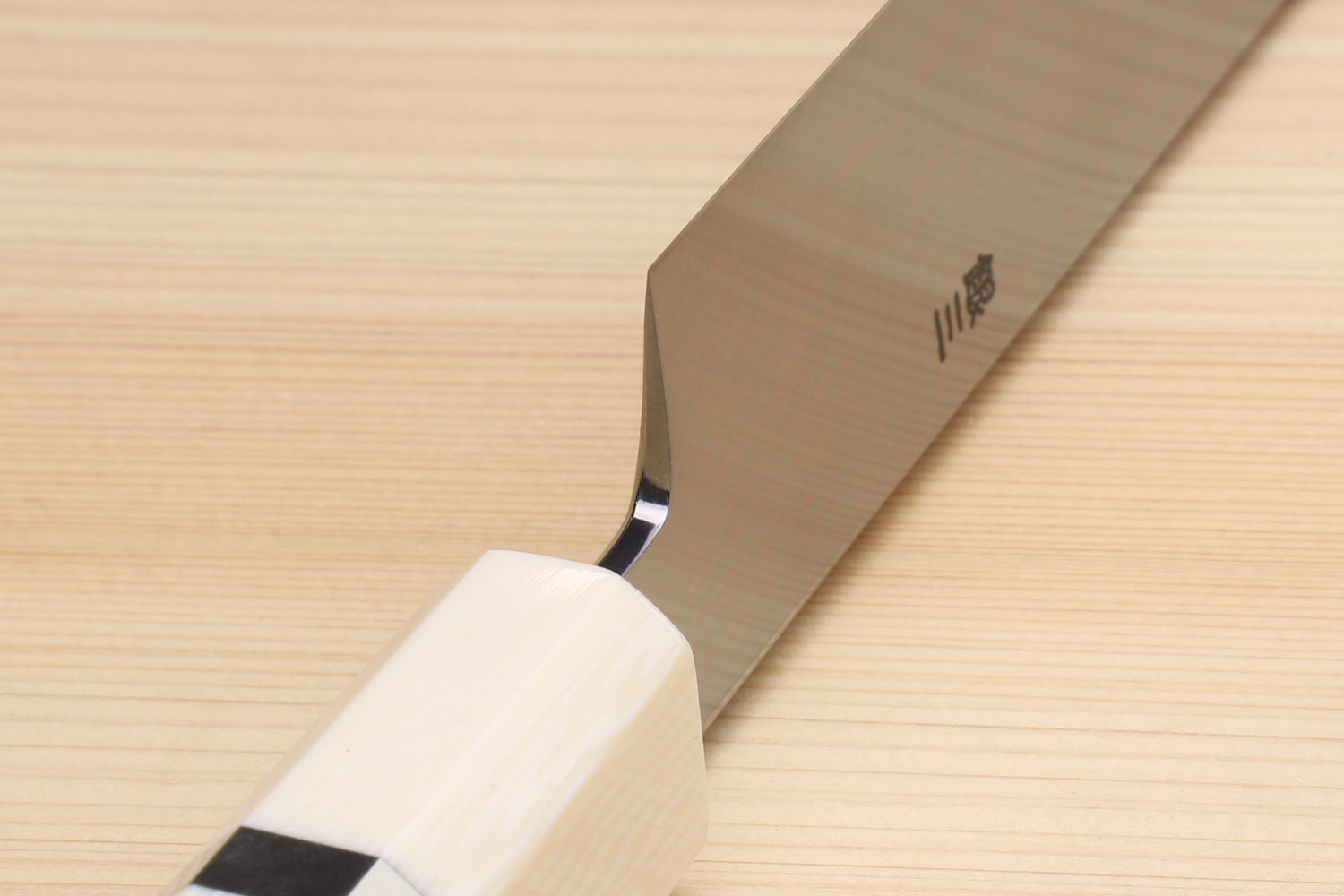 Japanese yanagi knife with ivory bolster and stainless blade near the handle