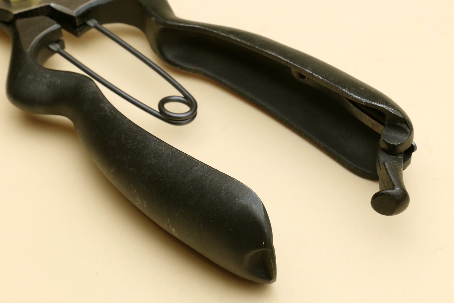 Pruning shears with black handles and metal spring latch, side view