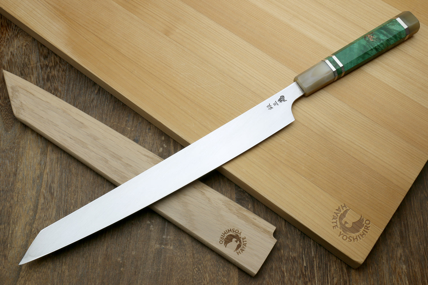 Japanese sushi knife with mirror-finished stainless blade and green-accent stabilized maple handle
