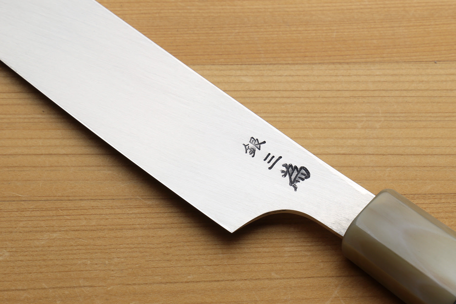Japanese sushi knife with engraved stainless steel blade and green-accent handle