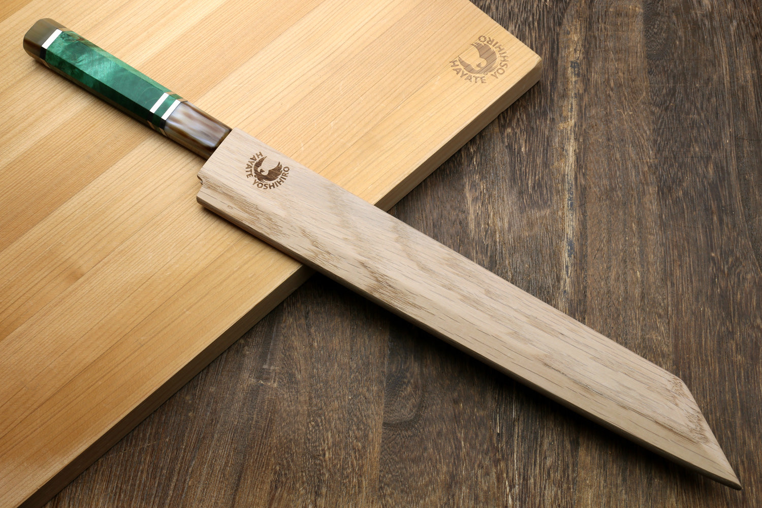 Japanese sushi knife with mirror-finished stainless blade and green-accent handle