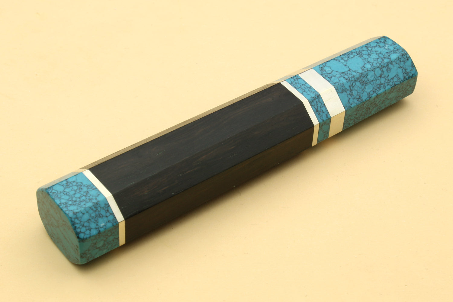 Turquoise-blue knife handle with long black section and white double stripes