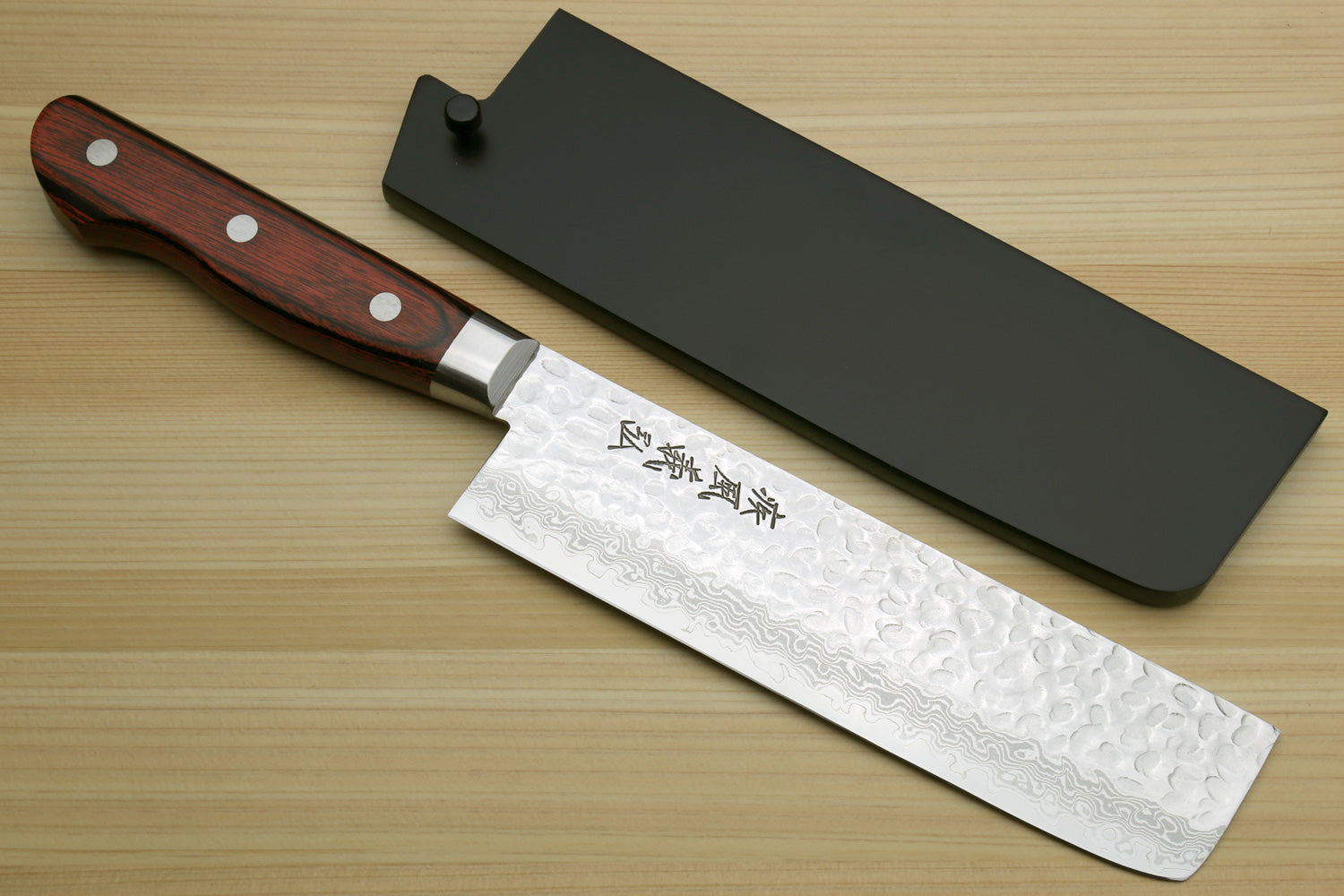 Nakiri vegetable knife with hammered Damascus-style stainless blade, dark wood handle, black cover