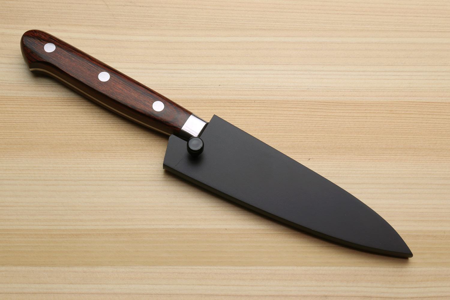 Paring knife with dark brown wood handle, hammered Damascus blade, in black sheath