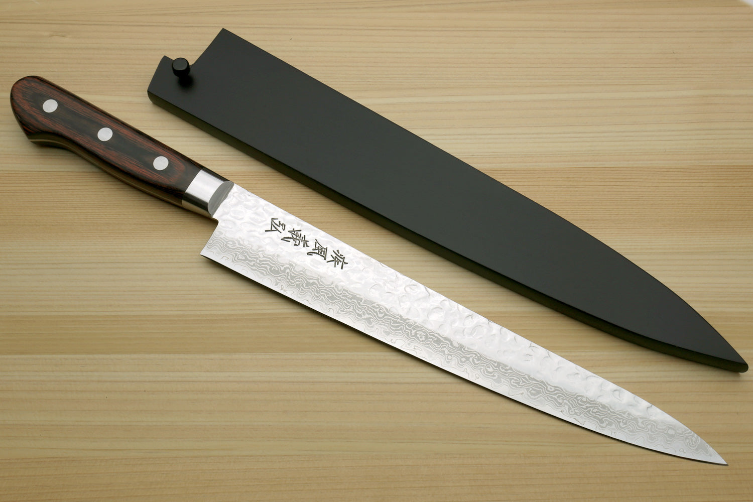 Sujihiki chef knife with black saya cover and hammered Damascus blade