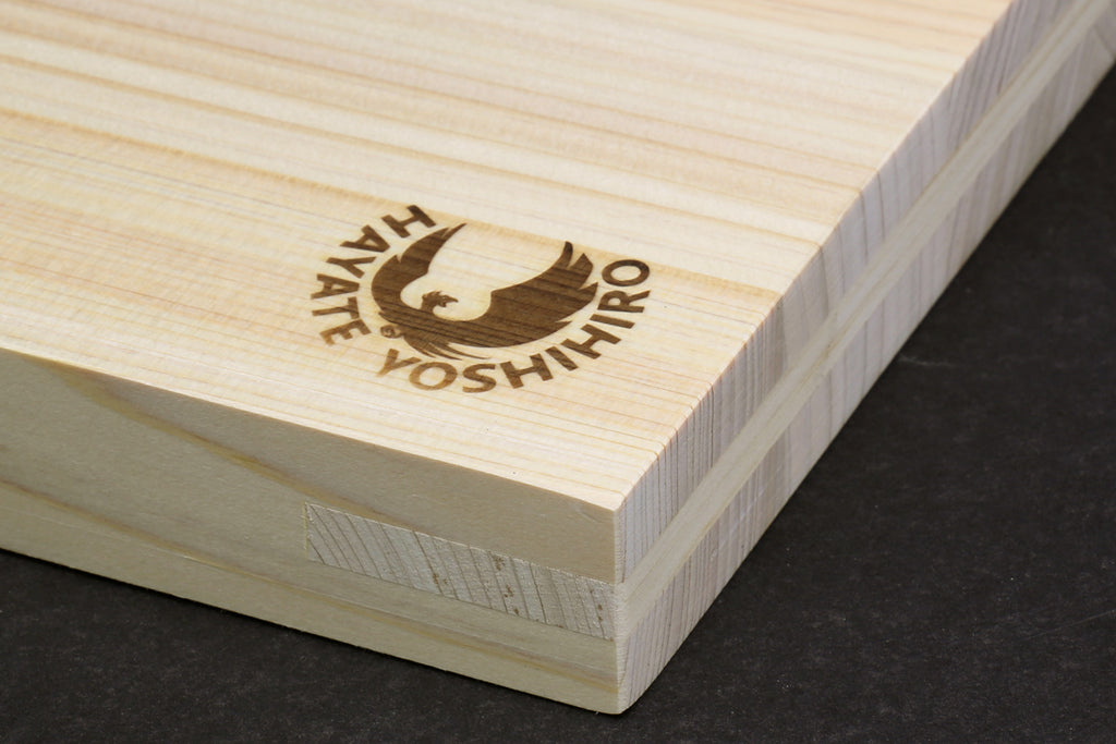 Japanese cypress cutting board corner with Yoshihiro logo and visible wood grain