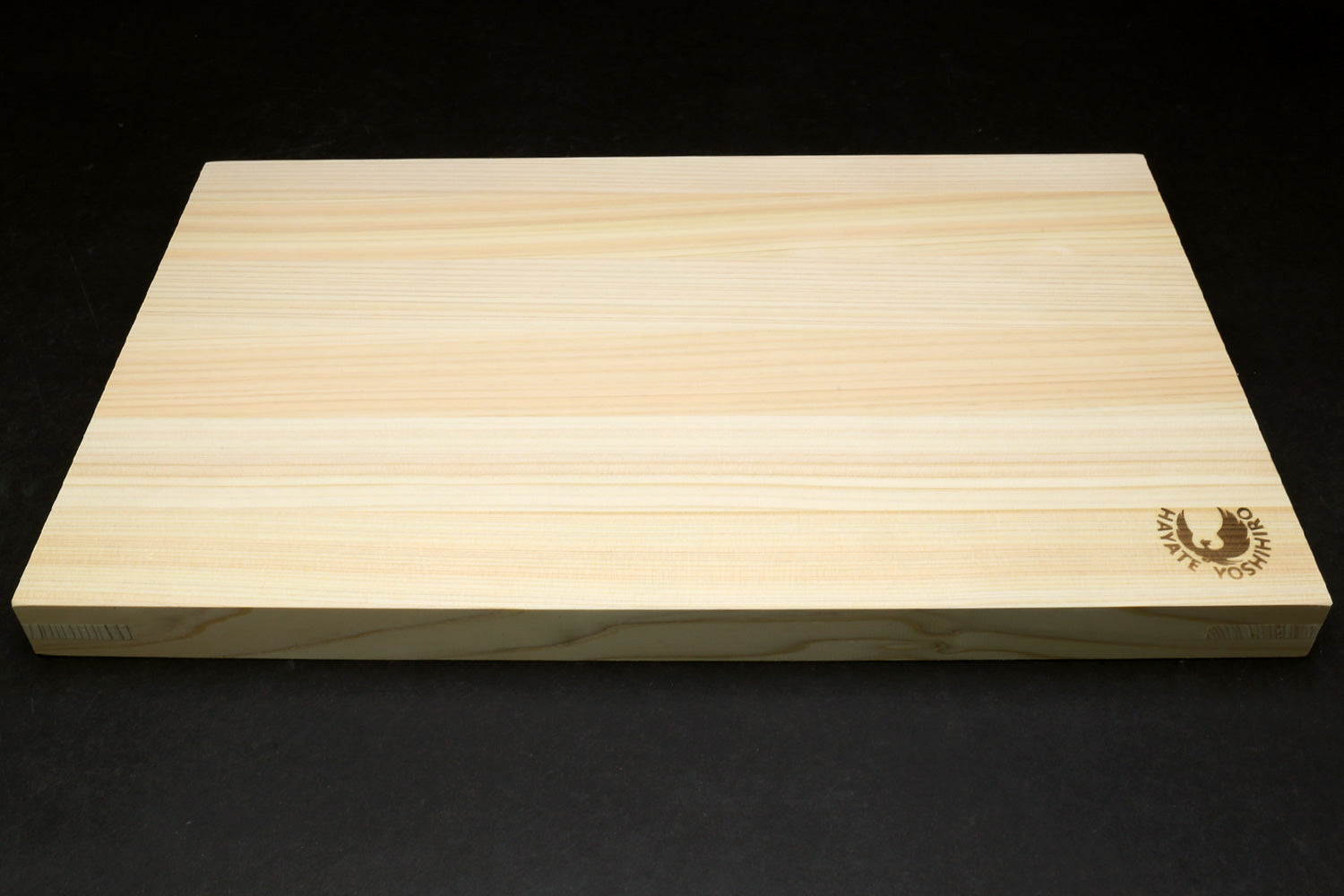 Japanese cypress cutting board side profile with Yoshihiro logo near corner