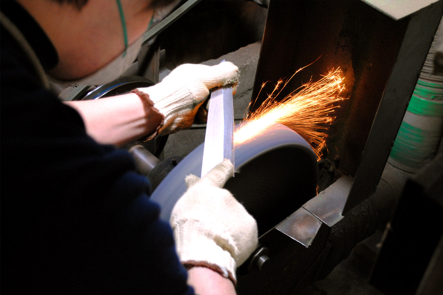 Knife being sharpened in Japanese blacksmith studio