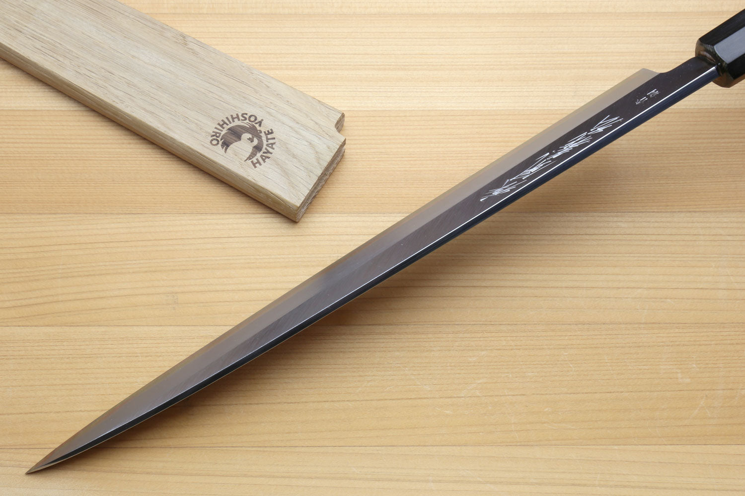 Yanagiba sashimi knife with dark handle, silver blade and engraved bolster area