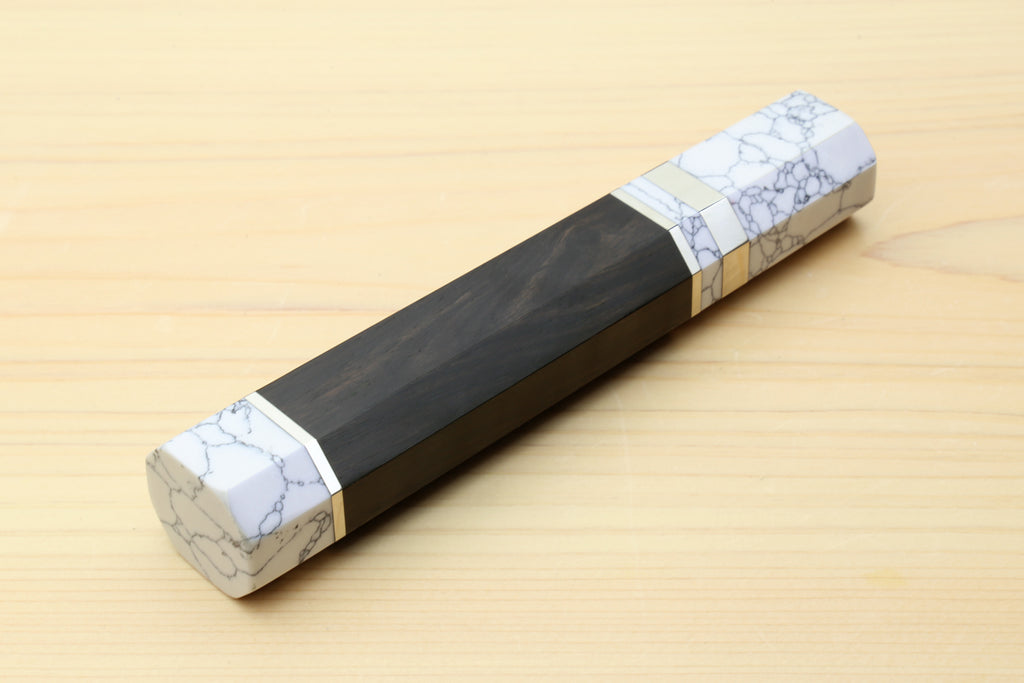 Ebony knife handle with white howlite bolster and gold-tone band detail