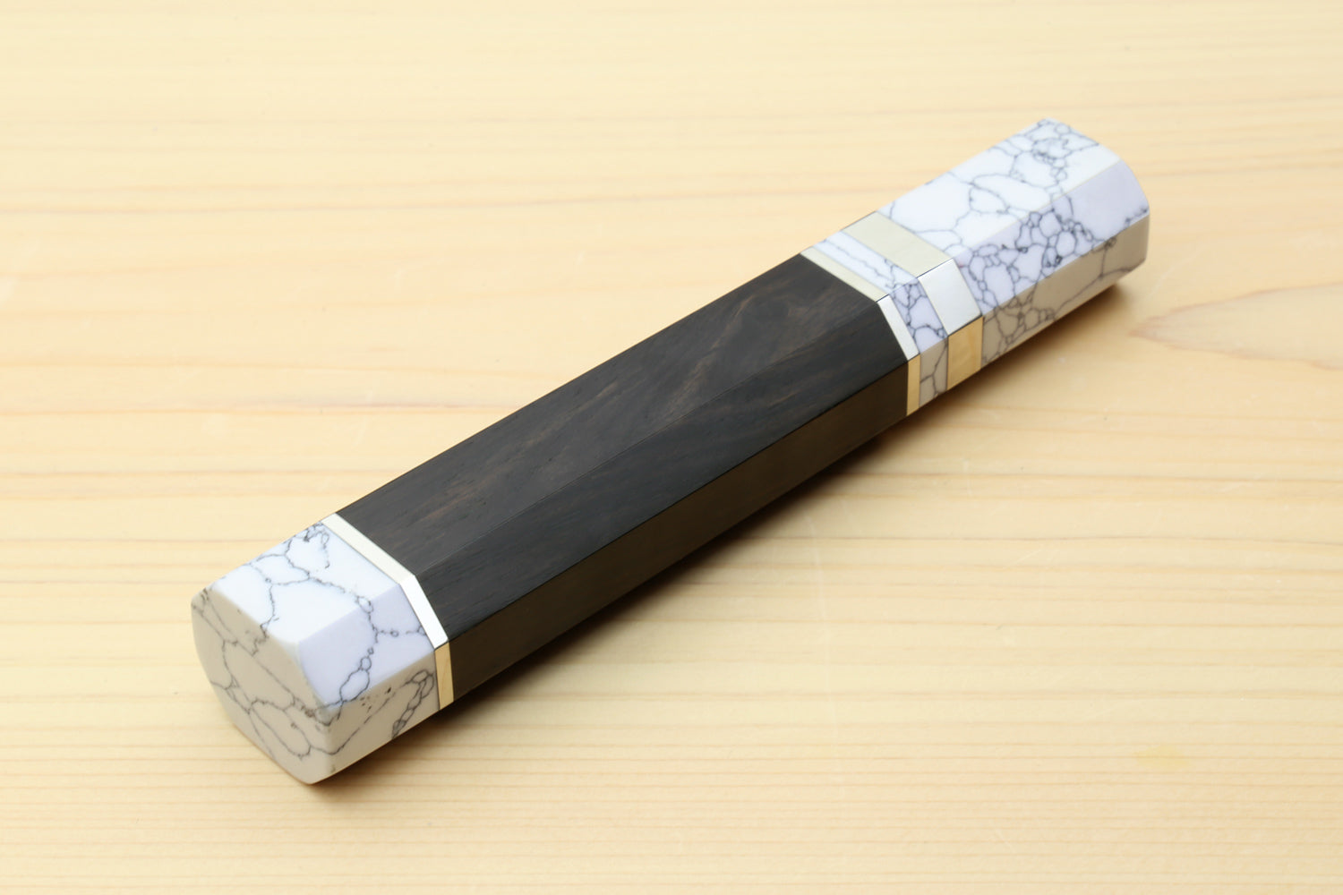 Ebony knife handle with white howlite bolster and gold-tone band detail