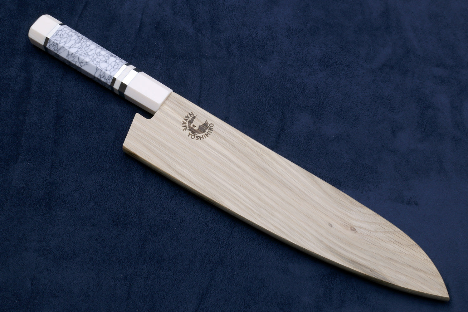Chef's gyuto knife with white blade and ivory-pattern handle; straight edge.