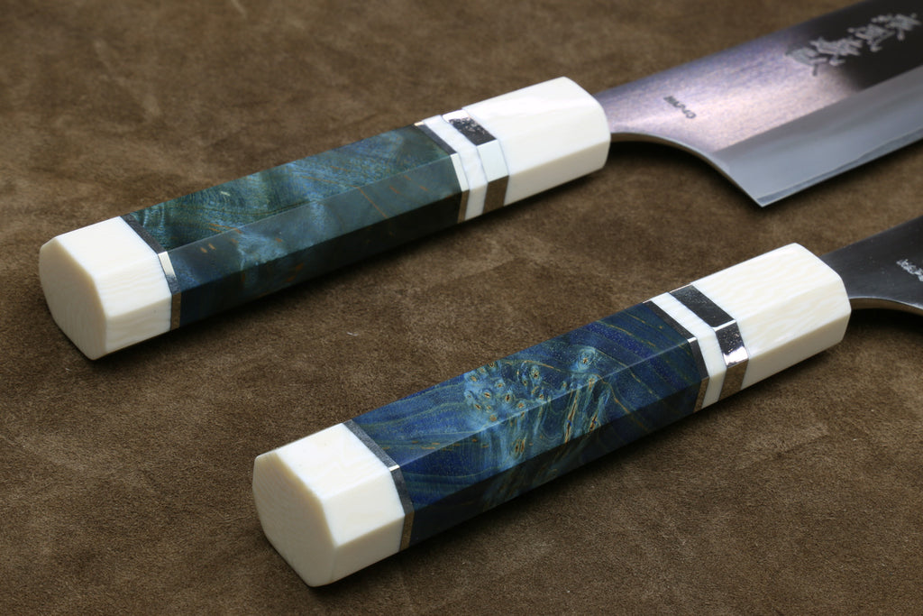 Pair of gyuto chef knives with octagonal ivory handles, blue patterned wrap, dark bands