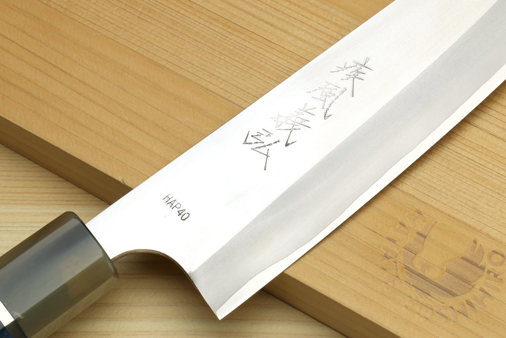 Gyuto chef's knife blade with etched marks and HAP40 text